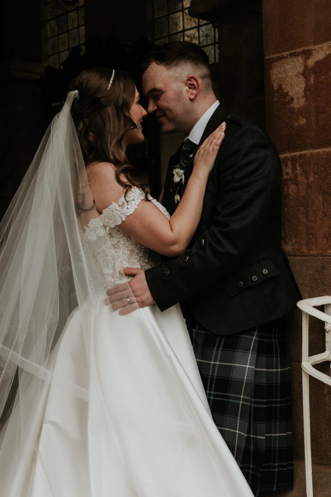 Cornhill Castle Bride & Groom snuggle at the doorway