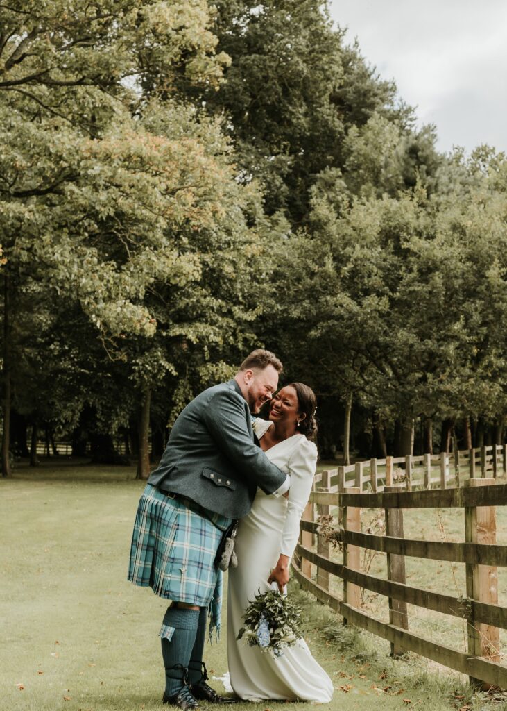 Bride and Groom laughing at Calrowrie Castle